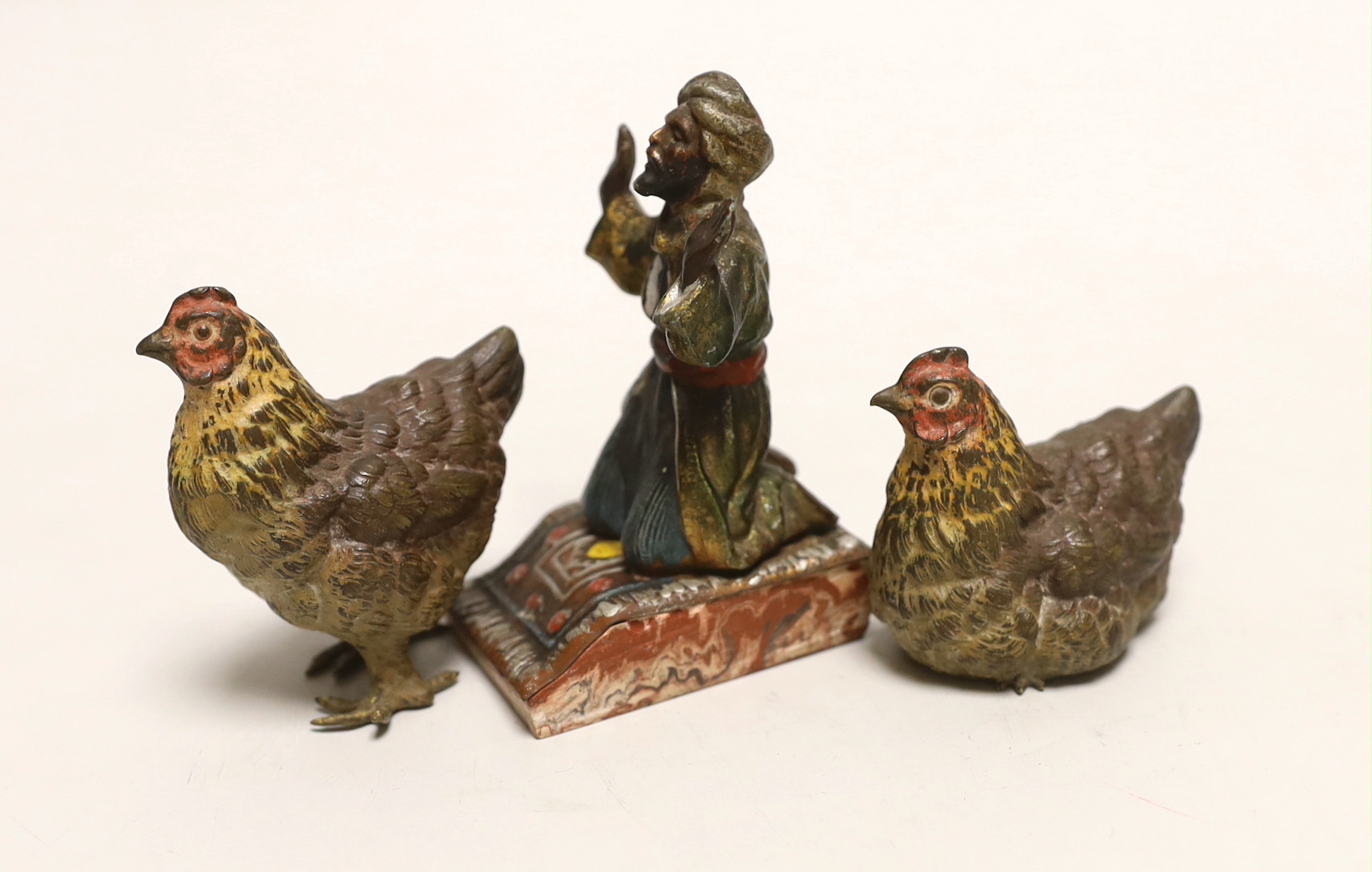 Two Austrian cold painted bronze chickens and a painted metal kneeling man, tallest 9cm